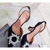 Amina Muaddi black heels